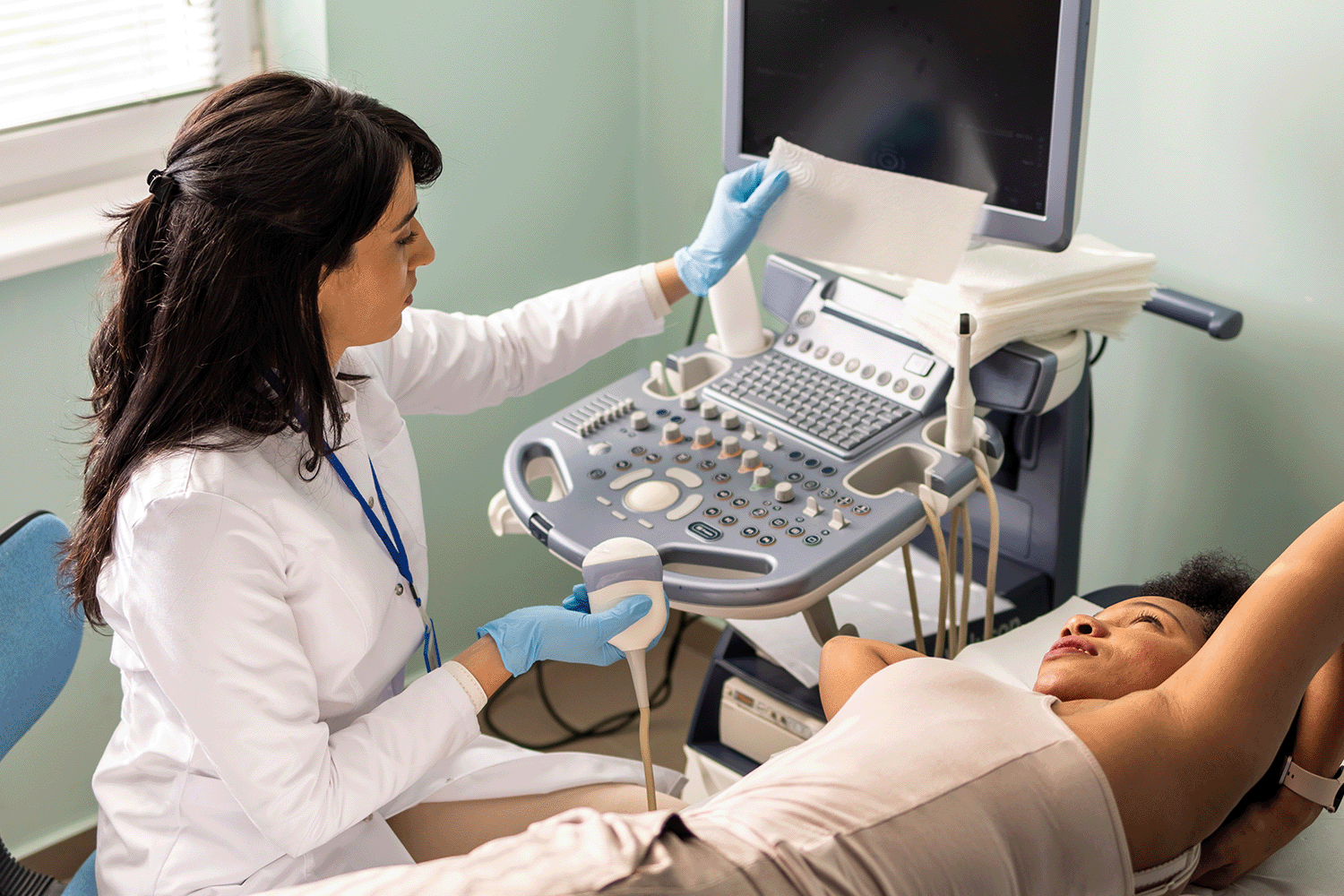 A healthcare worker performing a scan on a patient