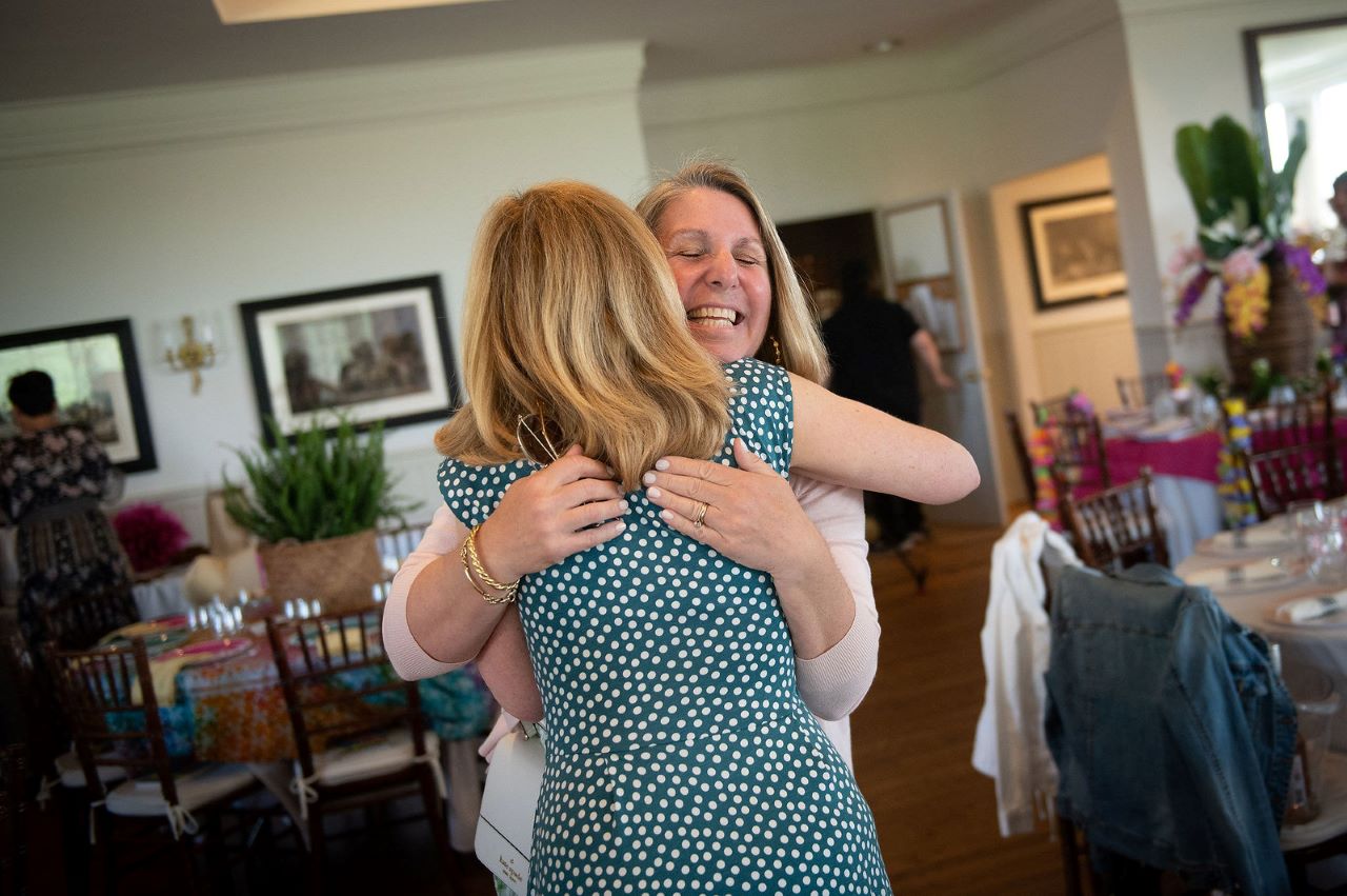 Two women hugging at an event